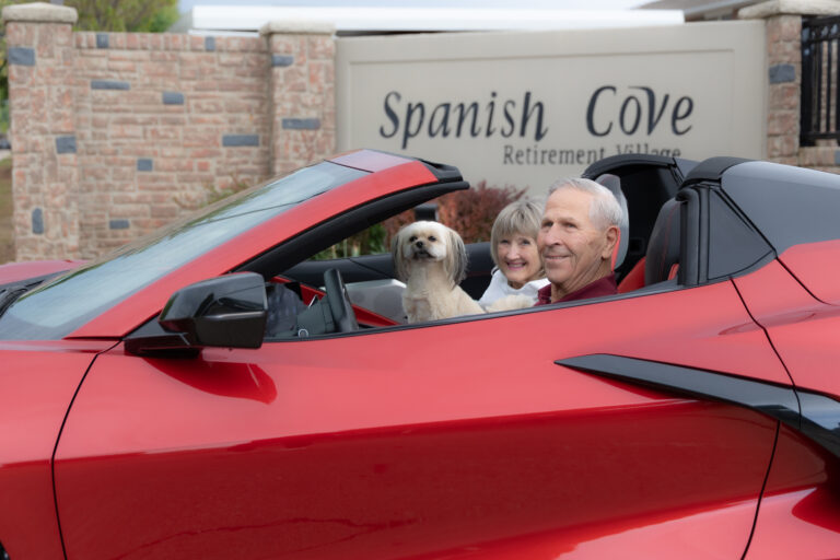 Spanish Cove senior living members in a convertible car in Yukon, OK