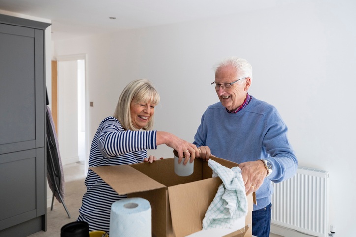 Elderly couple packing boxes to downsize home for easier living in Yukon, OK