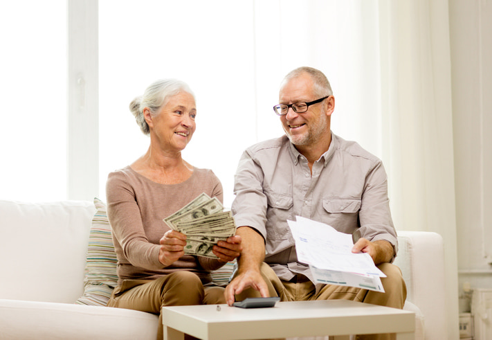 Cost of Senior Living Two senior adults discussing paying for senior living options in Yukon, OK