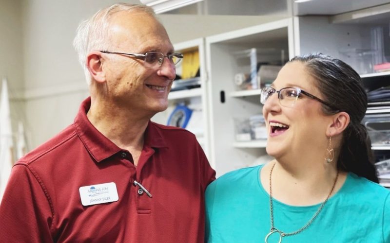 An adult woman caring for an elderly parent symbolizes the Sandwich Generation in Yukon, OK