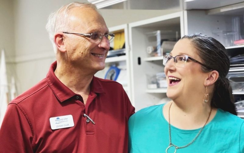 An adult woman caring for an elderly parent symbolizes the Sandwich Generation in Yukon, OK